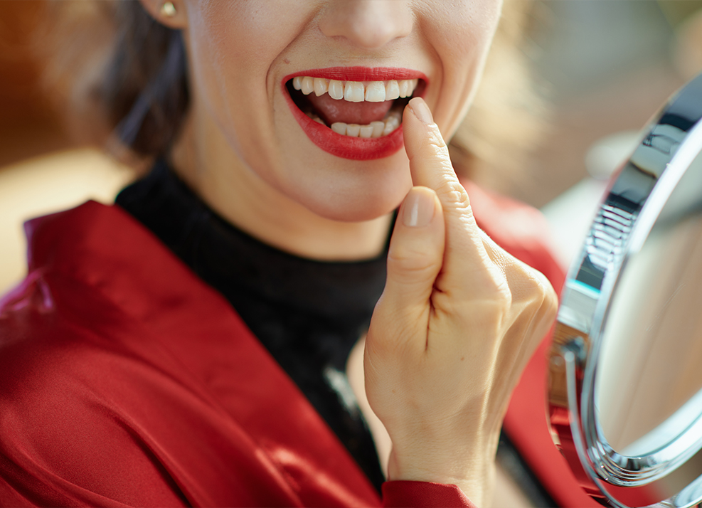 Woman pointing to smile after dental bonding