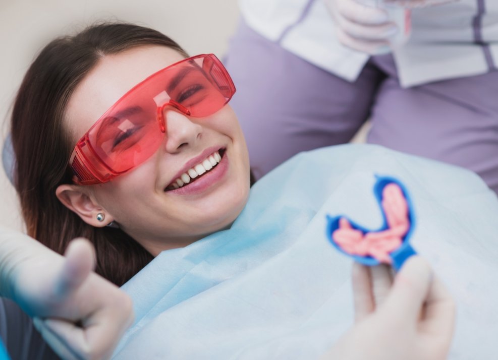 Smiling dental patient receiving fluoride treatment
