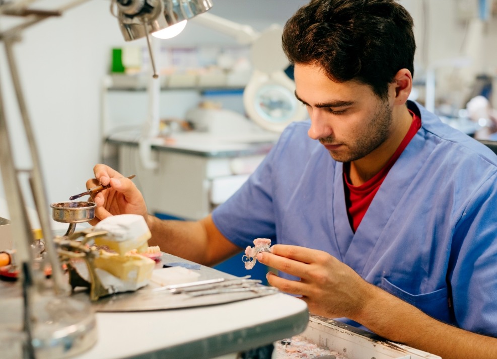 Prosthodontist crafting dental restoration