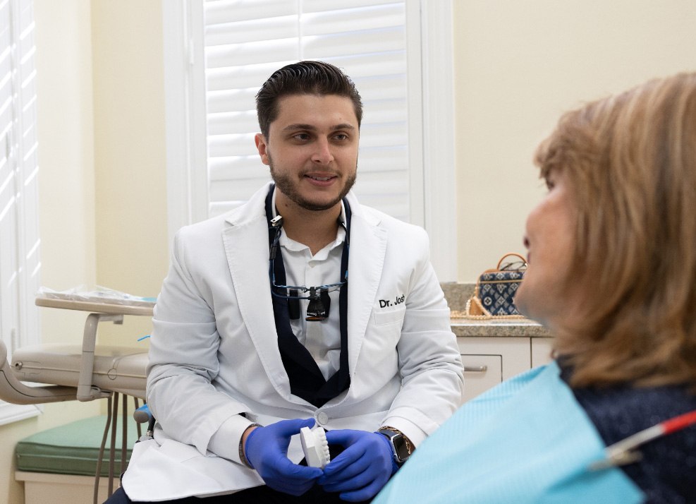 Dentist describing root canal treatment to dental patient