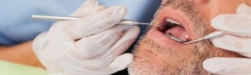 Dentist treating dental patient under sedation dentistry